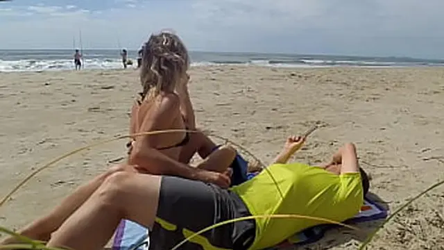 Hot milf seduces stranger with expert handjob on sandy shore